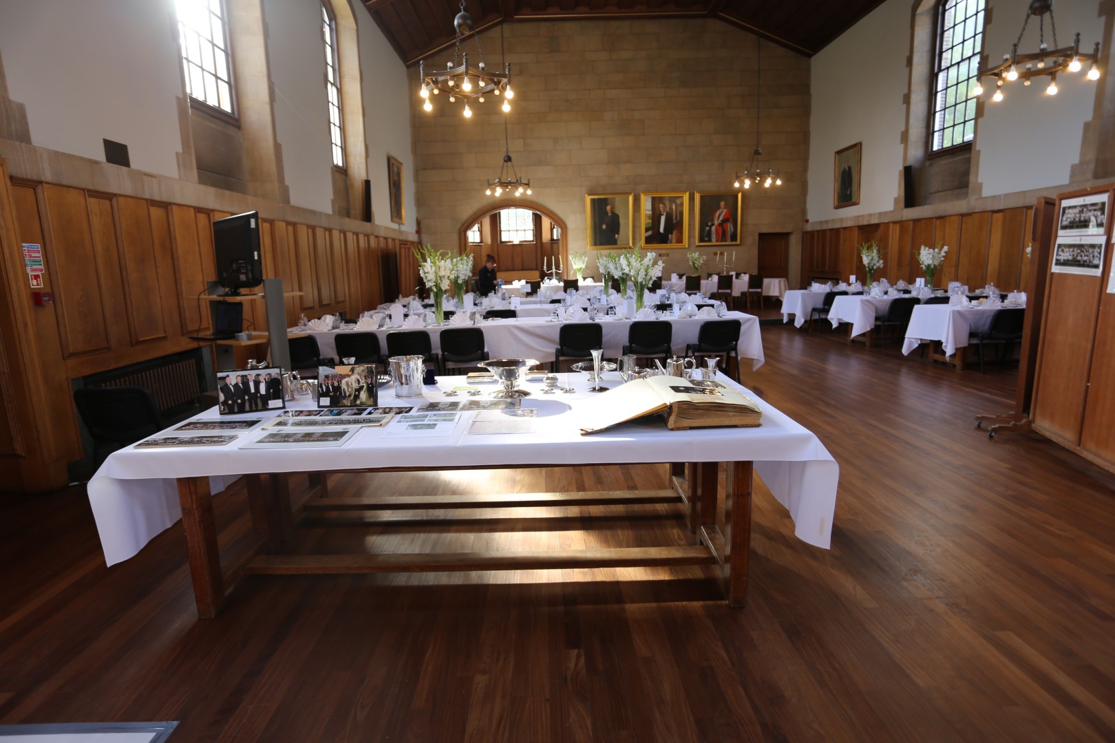 Cripps Hall Dining Room set with wooden tables and white table cloths for a formal dinner